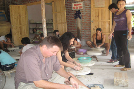 Visitors making ceramic products in Bat Trang Ceramic Village.