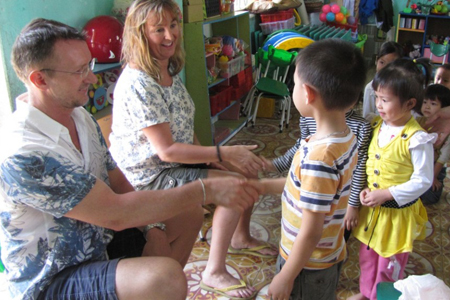 Visitors communicate with local children in Yen Duc Village