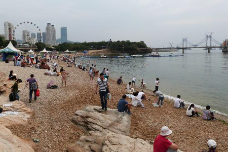 Tourists at the beach of Xinghai Park