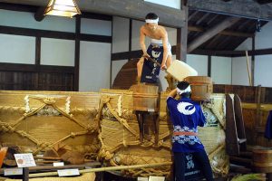 Two men performing sake-making steps in Hakutsuru Sake Brewery