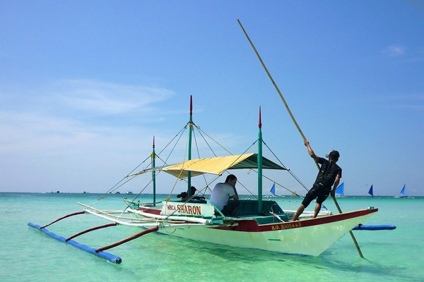 Boat in crystal clear water, Boracay Island