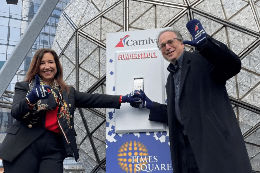 Christine Duffy with Emeril Lagasse flip the giant switch to light the New Year’s Eve Ball