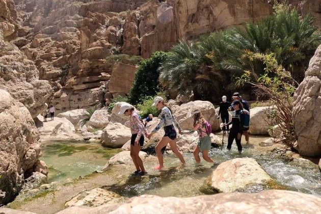 Hiking through Wadi Shab canyon - Muscat tours