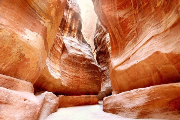 Narrow sandstone canyon walls inside Petra’s Siq