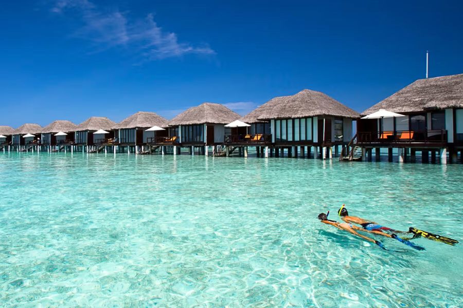 Water activities in a clear lagoon beside a Maldives resort