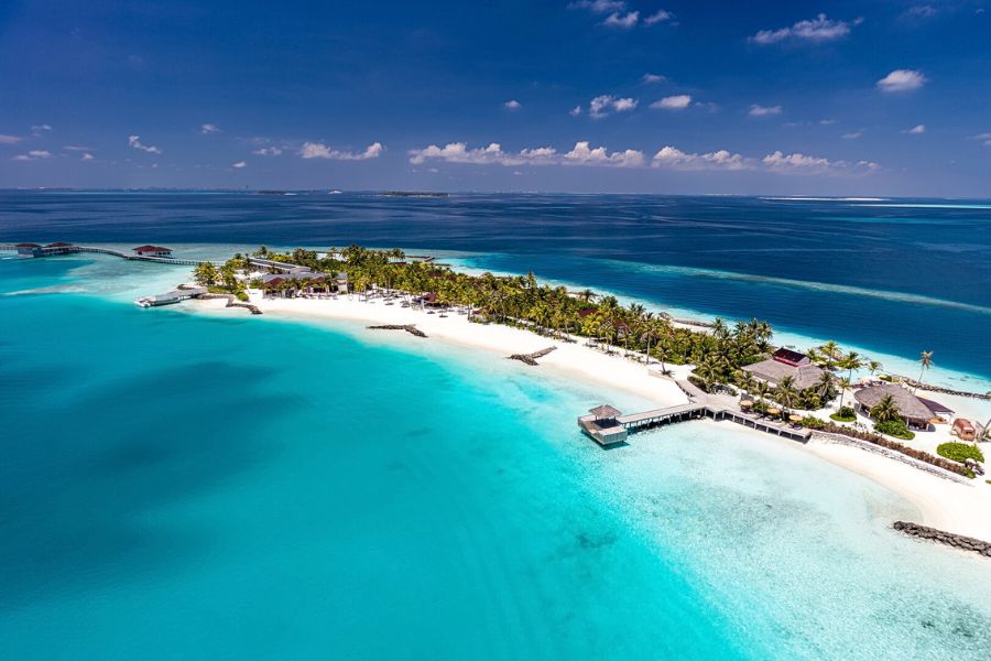 Maldives resort island surrounded by clear lagoon water
