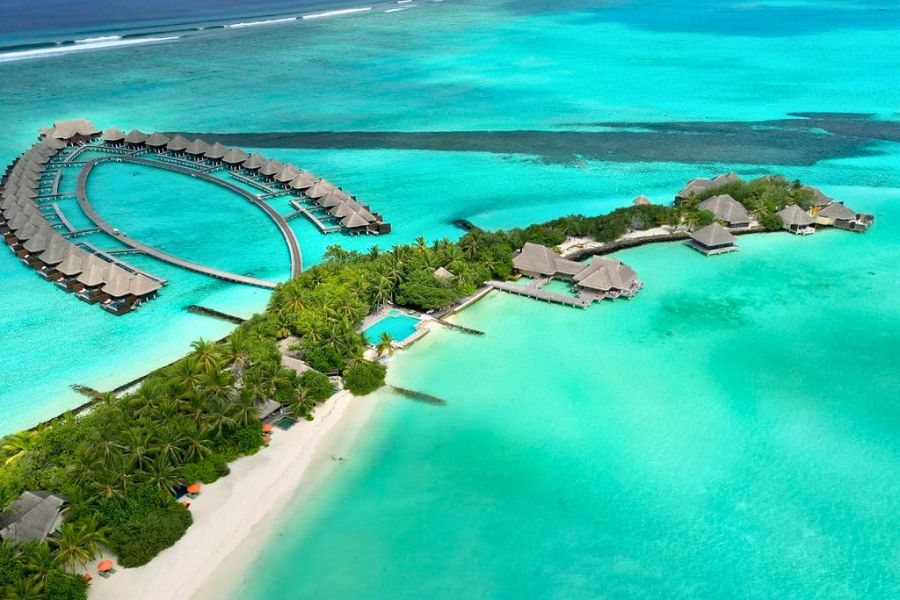 Maldives resort island with beach and overwater villas