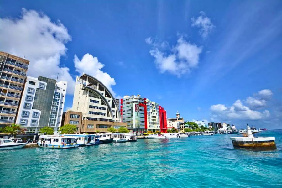 Malé waterfront with colourful buildings and local boats