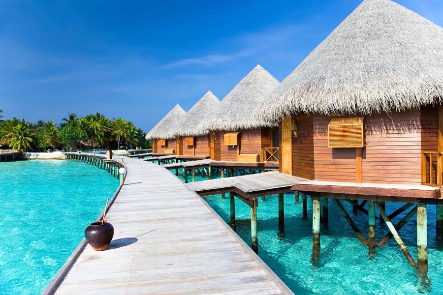 Overwater villas beside a bright Maldives lagoon in January