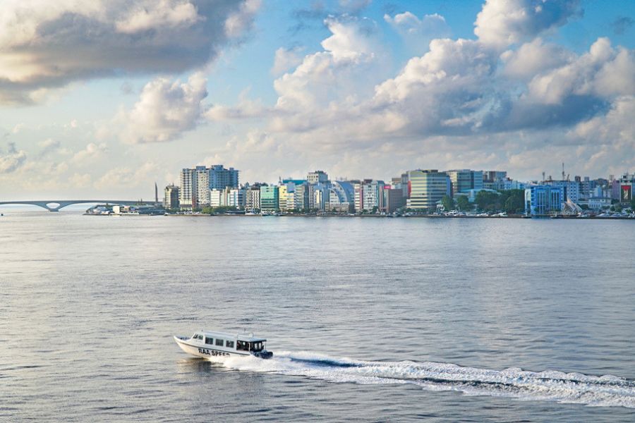 Speedboat crossing the lagoon in front of Malé City